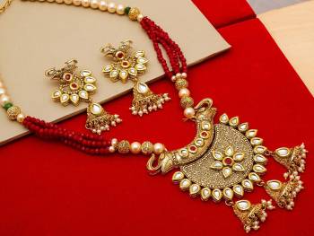 Give An Enhanced Look To Your Personality By Pairing Up This Beautiful Necklace Set With Your Ethnic Attire. This Pretty Set Is In Golden Color Beautified With Stone And Pearl Work. Buy Now.