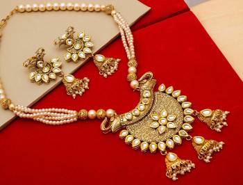 Give An Enhanced Look To Your Personality By Pairing Up This Beautiful Necklace Set With Your Ethnic Attire. This Pretty Set Is In Golden Color Beautified With Stone And Pearl Work. Buy Now.