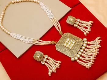 Give An Enhanced Look To Your Personality By Pairing Up This Beautiful Necklace Set With Your Ethnic Attire. This Pretty Set Is In Golden Color Beautified With Stone And Pearl Work. Buy Now.