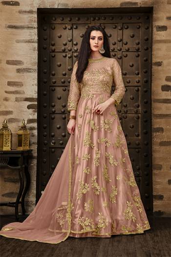 Add This Very Pretty Rich And Elegant Looking Designer Floor Length Suit In Dusty Pink Color. This Heavy Embroidered Suit IS Net Based Paired With Santoon Bottom And Net Dupatta. Its Rich Color And Elegant Embroidery Will earn You Lots Of Compliments From onlookers. Buy Now.