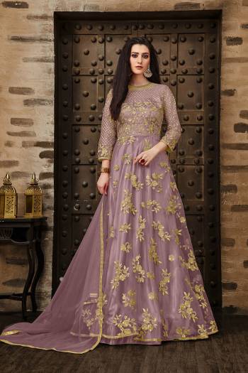 Add This Very Pretty Rich And Elegant Looking Designer Floor Length Suit In Lilac Color. This Heavy Embroidered Suit IS Net Based Paired With Santoon Bottom And Net Dupatta. Its Rich Color And Elegant Embroidery Will earn You Lots Of Compliments From onlookers. Buy Now.