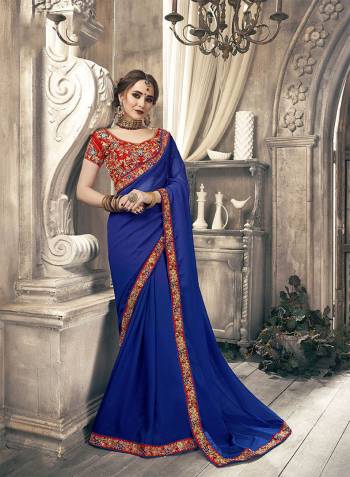 Bright And Visually Appealing Color Is Here With This Pretty Designer Saree In Royal Blue Color Paired With Contrasting Red Colored Blouse. This Saree Is Fabricated On Chiffon Paired With Art Silk Fabricated Heavy Embroidered Blouse.