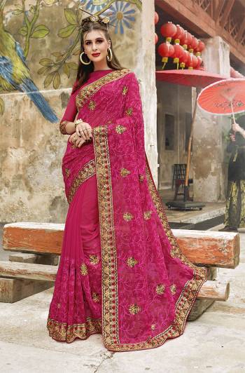 Catch All The Limelight At The Next Wedding You Attend Wearing This Heavy Designer Saree In Rani Pink Color Paired With Rani Pink Colored Blouse. This Saree And Blouse Are Fabricated on Georgette Beautified With Heavy Tone To Tone And Contrasting Embroidery. 