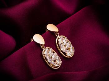 Here Is A Very Pretty Pair Of Simple And Elegant Looking Earring Set In Golden color. It Has Pretty Unique pattern With Attractive Diamond Work. You can Pair This Even With Simple Attire As Well As A Heavy One. This Pretty Evergreen Design Compliments Any Kind Of Attire You Wear. 