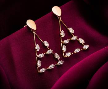 Here Is A Very Pretty Pair Of Simple And Elegant Looking Earring Set In Golden color. It Has Pretty Unique pattern With Attractive Diamond Work. You can Pair This Even With Simple Attire As Well As A Heavy One. This Pretty Evergreen Design Compliments Any Kind Of Attire You Wear. 