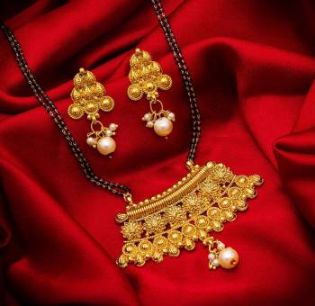 Grab This Heavy Double Chained Magalsutra Set Which Has A Heavy Designer Attatched Pendant With A Pair Of Earrings. This Mangalsutra Can Be Paired With Any Colored Traditional Attire And Suitable For Occasion Wear. Buy Now