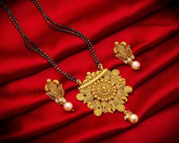 Grab This Heavy Double Chained Magalsutra Set Which Has A Heavy Designer Attatched Pendant With A Pair Of Earrings. This Mangalsutra Can Be Paired With Any Colored Traditional Attire And Suitable For Occasion Wear. Buy Now