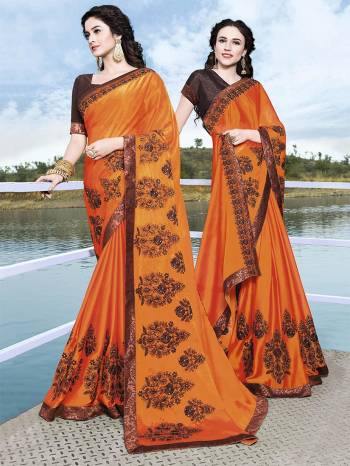 Celebrate This Festive Season with Beauty And Comfort Wearing This Heavy Designer Saree In Orange Color Paired With Contrasting Brown Colored Blouse. This Saree Is Fabricated On Satin Chiffon Paired With Art Silk Fabricated Blouse. Get This Amazing Saree To Your Wardrobe Now.