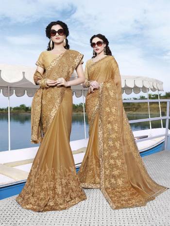 Flaunt Your Rich And Elegant Taste Wearing This Designer Saree In Beige Color Paired With Beige Colored Blouse. This Saree Is Satin Chiffon Based Paired With Art Silk Fabricated Blouse. It IS Beautified With Tone To Tone Embroidery Which Also Gives A Rich And Subtle Look. 