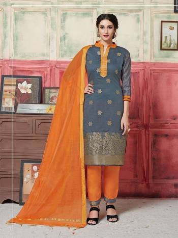 Simple Dress Material Is Here For Your Semi-Casual wear In Grey Colored Top Paired With Contrasting Orange Colored Bottom And Dupatta. This Silk Based Dress Material Is Beautified With Weave. Buy Now.