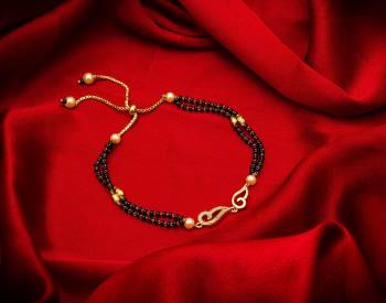 Here Is Very Pretty And Trending Mangalsutra Bracelet In Black And Gold. This Mangalsutra Bracelet Has A Pretty Delicate Design And Pattern Which Gives An Elegant Look To Your Wrist. Buy This Latest Trend Now.