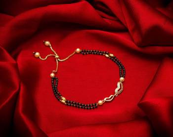 Here Is Very Pretty And Trending Mangalsutra Bracelet In Black And Gold. This Mangalsutra Bracelet Has A Pretty Delicate Design And Pattern Which Gives An Elegant Look To Your Wrist. Buy This Latest Trend Now.