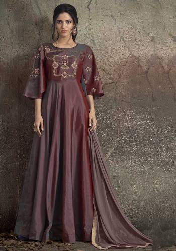 A Must Have Shade In Every Womens Wardrobe IS Here With This Designer Floor Length Suit In Wine Color. Its Silk Based Top Is Fully Stitched Beautified With Embroidery And Bell Sleeve Pattern Paired With Santoon Bottom And Chiffon Dupatta. 