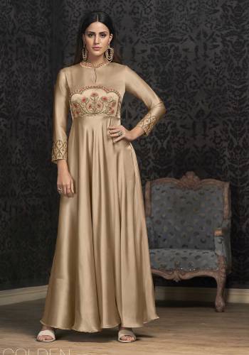 Rich And Elegant Looking Designer Readymade Gown Is Here In Beige Color Fabricated On Satin Silk. Its Has Very Pretty Subtle Embroidery Over The Yoke And Sleeves. Buy Now.