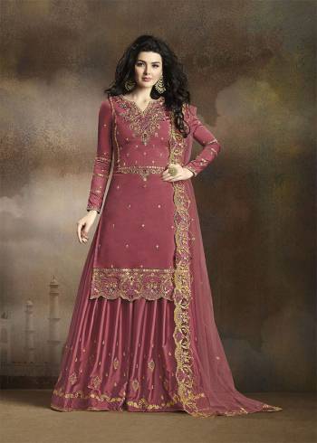 Look Beautiful Wearing This Heavy Designer Suit In Old Rose Pink Color. Its Has Heavy Embroidered Top, Bottom And Dupatta. Its Top Is Fabricated On Soft Silk Paired With Santoon Bottom And Net Fabricated Dupatta. Buy This Pretty Suit Now.