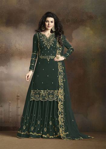 Look Beautiful Wearing This Heavy Designer Suit In Pine Green Color. Its Has Heavy Embroidered Top, Bottom And Dupatta. Its Top Is Fabricated On Soft Silk Paired With Santoon Bottom And Net Fabricated Dupatta. Buy This Pretty Suit Now.