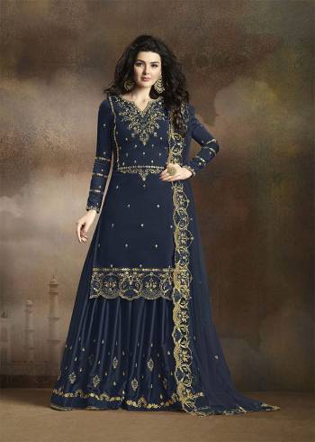 Look Beautiful Wearing This Heavy Designer Suit In Navy Blue Color. Its Has Heavy Embroidered Top, Bottom And Dupatta. Its Top Is Fabricated On Soft Silk Paired With Santoon Bottom And Net Fabricated Dupatta. Buy This Pretty Suit Now.