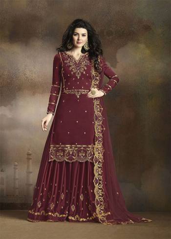 Look Beautiful Wearing This Heavy Designer Suit In Maroon Color. Its Has Heavy Embroidered Top, Bottom And Dupatta. Its Top Is Fabricated On Soft Silk Paired With Santoon Bottom And Net Fabricated Dupatta. Buy This Pretty Suit Now.