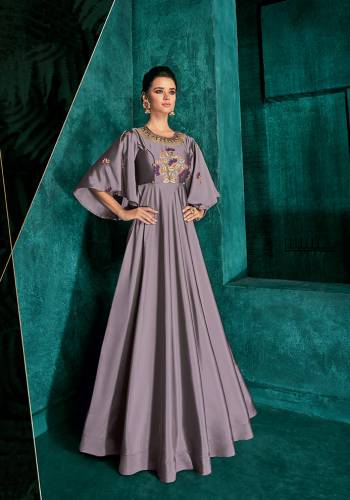 New And Unique Shade In Purple Is Here With This Designer Readymade Gown In Mauve Color Fabricated On Soft Art Silk. It Has Very Graceful Bell Sleeve Pattern And Beautified With Contrasting Embroidery. 