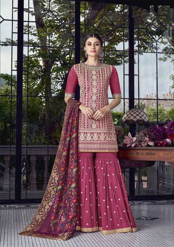 Bright And Visually Appealing Color Is Here With This Heavy Designer Sharara Suit In Dark Pink Color Paired With Magenta Pink Colored Dupatta. Its Top Is Fabricated On Soft Silk Paired With Georgette Bottom And Jacquard Silk Fabricated Dupatta. 