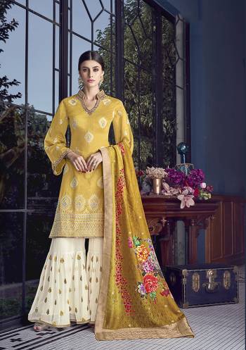 Celebrate This Festive Season Wearing This Heavy Designer Sharara Suit In Musturd Yellow Colored Top And Dupatta Paired With Off-White Colored Bottom. Its Top Is Silk Based Paired With Georgette Bottom And Jacquard Silk Dupatta. 