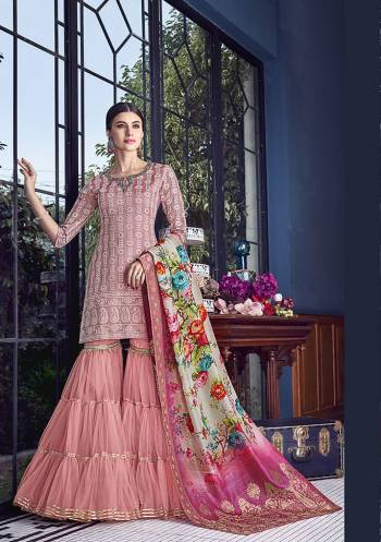 You Will Definitely Earn Lots Of Compliments Wearing This Heavy Designer Sharara Suit In All Over Pink Color. Its Top And Dupatta Are Silk Paired With Net Fabricated Bottom. Grab This Lovely Piece Now.