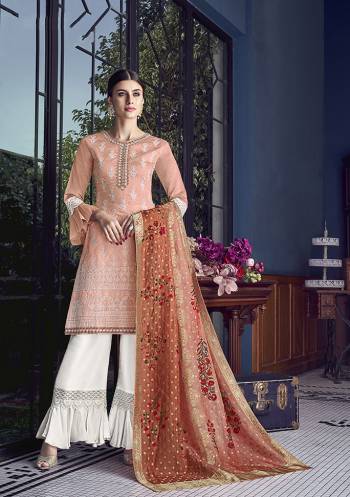 A Must Have Shade In Every Womens Wardrobe Is Here With This Heavy Designer Sharara Suit In Peach Colored Top Paired With White Colored Bottom And Dark Peach Colored Dupatta. Its Top Is Fabricated On Soft Silk Paired With Satin Silk Bottom And Jacquard Silk Dupatta. 