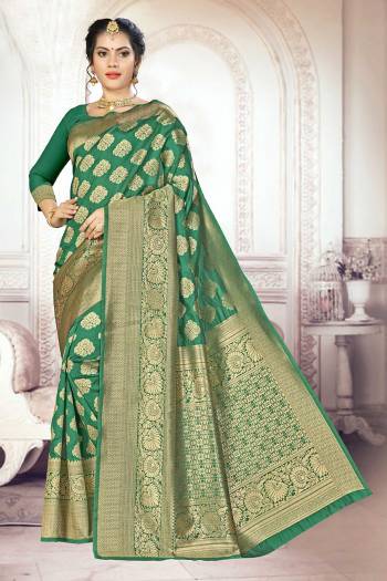 Add This Very Pretty Silk Based Saree To Your Wardrobe In Green Color. This Saree Is Fabricated On Banarasi Art Silk Paired With Art Silk Fabricated Blouse. It Is Beautified With Floral Weave All Over It