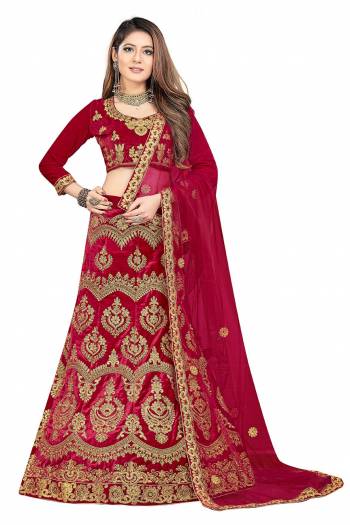 Here Is A Very Beautiful And Heavy Designer Lehenga Choli For Bridal Wear In All Over Maroon Color. Its Blouse And Lehenga Are Velvet Based Paired With Net Fabricated Dupatta. Its Heavy Embroidery And Rich Fabric Will Earn You Lots Of Compliments From Onlookers. 