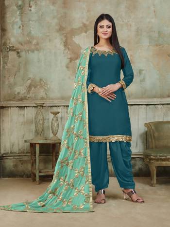 Grab This Very Beautiful And Attractive Looking Designer Suit In Blue Color Paired With Light Blue Colored Dupatta. Its Top Is Fabricated On Satin Beautified With Embroidery Over Neckline, Paired With Santoon Fabricated Bottom And With Heavy Gota Work Chinon Fabricated Dupatta. The Main Highlight Of This Beautiful Suit Is Its Heavy Dupatta Which Has Gota Work. Buy This Suit Now.