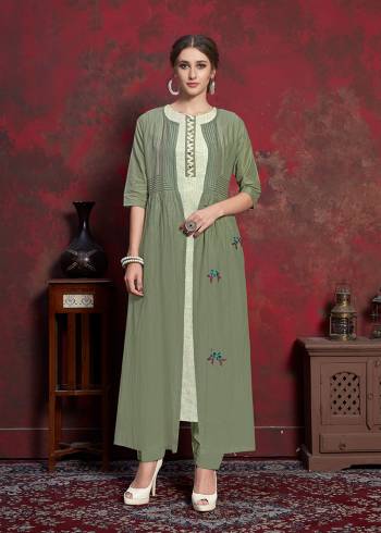 Here Is A Beautiful Jacket Patterned Designer Readymade Kurti In Off-White Colored Inner With Olive Green Colored Jacket. Printed Inner Is Fabricated On Rayon Cotton Paired With Muslin Fabricated Embroidered Jacket. It Is Light In Weight And Easy To Carry All Day Long. 