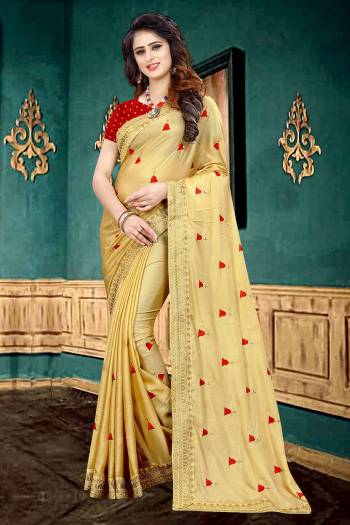 Get Ready For The Upcoming Festive Or Party With This Beautiful Designer Georgette Based Saree In Golden Color Which Has Lovely Glitter Padding Paired With Contrasting Red Colored Brocade Blouse. It Is Beautified with Elegant And Subtle Embroidered Lace Border And Butti. 