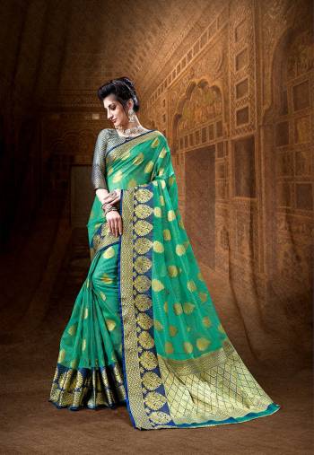 Grab This Very Beautiful Designer Silk Based Saree In Sea Green Color Paired With contrasting Navy Blue Colored Blouse. This Saree And Blouse Are Fabricated On Art Silk Beautified With Weave All Over It. 