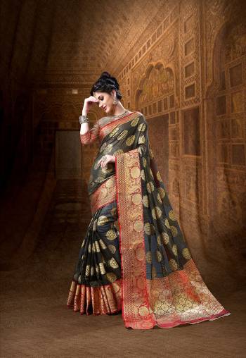 Here Is A Rich Silk Based Designer Saree In Black Color Paired With Red Colored Blouse. This Saree And Blouse Are Fabricated On Art Silk Beautified With Weave All Over It. Its Rich Fabric And Color Will Definitely Earn You Lots Of Compliments From Onlookers.