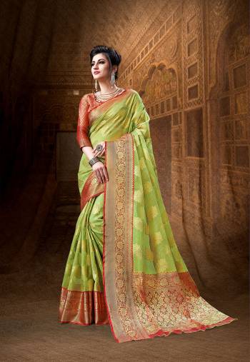 Here Is A Rich Silk Based Designer Saree In Light Green Color Paired With Red Colored Blouse. This Saree And Blouse Are Fabricated On Art Silk Beautified With Weave All Over It. Its Rich Fabric And Color Will Definitely Earn You Lots Of Compliments From Onlookers.