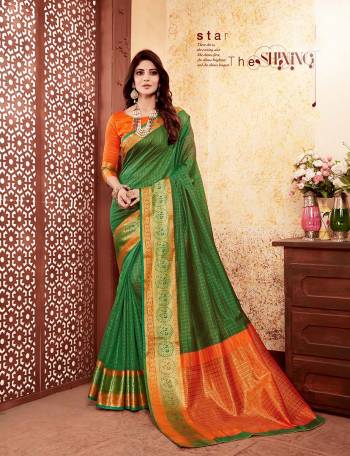 Here Is Proper Traditional Color  Pallete With This Silk Based Saree In Dark Green Color Paired With Contrasting Orange Colored Blouse. This Saree And Blouse Are Fabricated On Banarasi Art Silk Beautified Weave. 