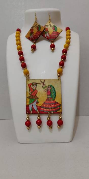 Grab This Unique Styled Necklace Set For This Navratri Festive In Multi Color. This Pretty Set Is Made Of Wood and Mix Metal Beautified With Prints And Bead Work. You Can Pair This Up With Any Contrasting Colored Attire. Buy Now.