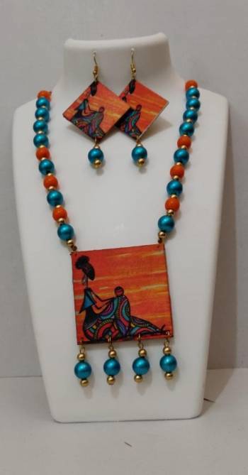 Grab This Unique Styled Necklace Set For This Navratri Festive In Multi Color. This Pretty Set Is Made Of Wood and Mix Metal Beautified With Prints And Bead Work. You Can Pair This Up With Any Contrasting Colored Attire. Buy Now.