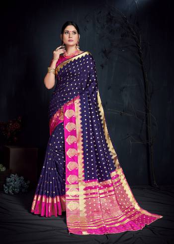 Adorn The Beautiful Festive Look Wearing This Silk Based Saree In Navy Blue Color Paired With Contrasting Rani Pink Colored Blouse. This Saree And Blouse Are Fabricated On Nylon Art Silk Beautified With Weave All Over. 