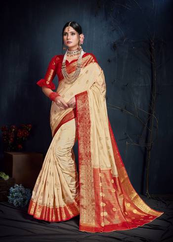 Flaunt Your Rich And Elegant Taste In This Subtle Cream Colored Saree Paired With Contrasting Red Colored Blouse. This Saree And Blouse Are Fabricated On Nylon Art Silk Beautified With Weave. Its Rich Fabric And Subtle Color Pallete Will Definitely Earn You Lots Of Compliments From Onlookers. 