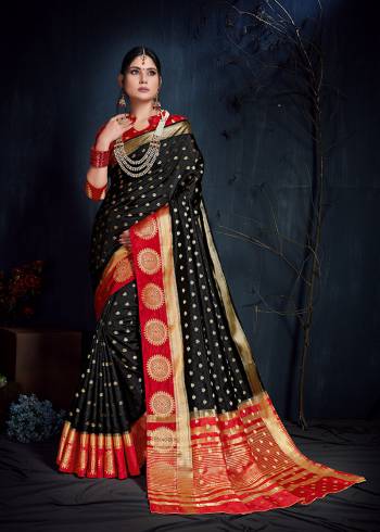 Adorn The Beautiful Festive Look Wearing This Silk Based Saree In Black Color Paired With Red Colored Blouse. This Saree And Blouse Are Fabricated On Nylon Art Silk Beautified With Weave All Over. 