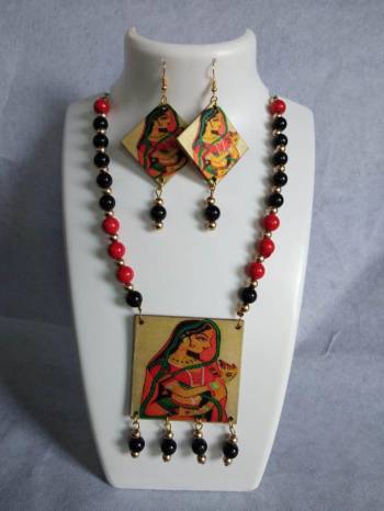 Grab This Unique Styled Necklace Set For This Navratri Festive In Multi Color. This Pretty Set Is Made Of Wood and Mix Metal Beautified With Prints And Bead Work. You Can Pair This Up With Any Contrasting Colored Attire. Buy Now.