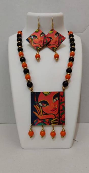 Grab This Unique Styled Necklace Set For This Navratri Festive In Multi Color. This Pretty Set Is Made Of Wood and Mix Metal Beautified With Prints And Bead Work. You Can Pair This Up With Any Contrasting Colored Attire. Buy Now.