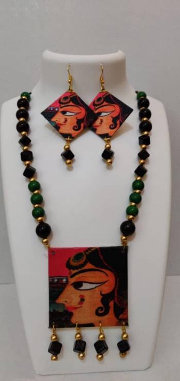 Grab This Unique Styled Necklace Set For This Navratri Festive In Multi Color. This Pretty Set Is Made Of Wood and Mix Metal Beautified With Prints And Bead Work. You Can Pair This Up With Any Contrasting Colored Attire. Buy Now.