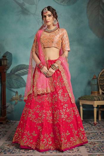 New And Unique Color Combination Is Here With This Heavy Designer Lehenga Choli In Peach Colored Blouse  Paired With Red Colored Lehenga And Pink Colored Dupatta. This Lehenga Choli Is Art Silk Based Paired With Net Fabricated Dupatta. This Also Comes With Two Diffrent Dupattas. 