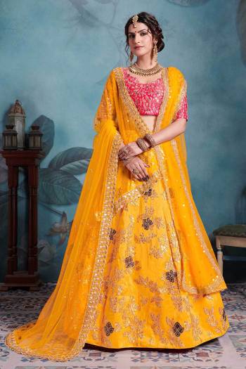 Bright And Visually Appealing Color Pallet Is Here With This Heavy Designer Lehenga Choli In Dark Pink Colored Blouse Paired With Contrasting Musturd Yellow Colored Lehenga And Dupatta. Its Blouse are Lehenga Are Fabricated On Art Silk Paired With Net Fabricated Two Dupattas. 