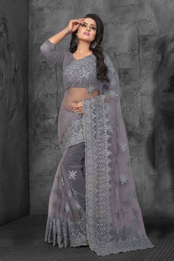 Flaunt Your Rich And Elegant Taste Wearing This Heavy Designer Saree In All Over Grey Color. This Heavy Tone To Tone Embroidered Saree And Blouse are Fabricated On Net. Its Fabric Is Light In Weight And Easy To Carry Throughout The Gala. 