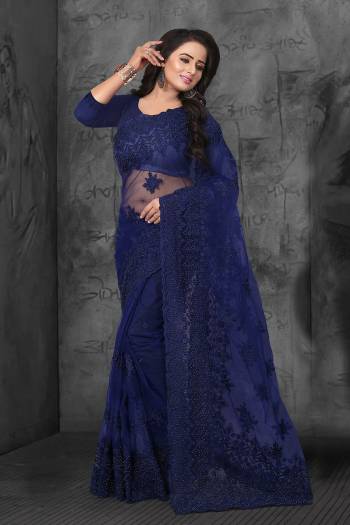 Enhance Your Personality In This Heavy And Attractive Looking Designer Saree In Navy Blue Color. This Saree And Blouse are Net Based Beautified With Tone To Tone Resham Embroidery And Ceramic Stone Work. 