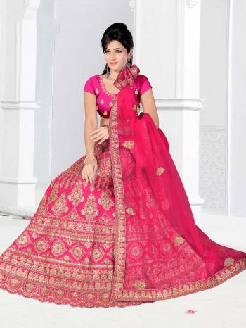 Here Is A Very Beautiful Heavy Designer Bridal Lehenga Choli In All Over Dark Pink. Its Blouse And Lehenga Are Fabricated On Satin Silk Paired With Net Fabricated Dupatta. It Is Beautified With Heavy Embroidery Giving It An Attractive Look. 