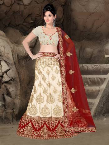 Flaunt Your Rich And Elegant Taste With Some Subtle Color Pallet In Your Bridal Wear. Grab This Heavy Designer Lehenga Choli In Cream Color Paired With Maroon Colored Dupatta. Its Blouse Are Lehenga are Satin Silk Based Paired With Net Fabricated Dupatta. 